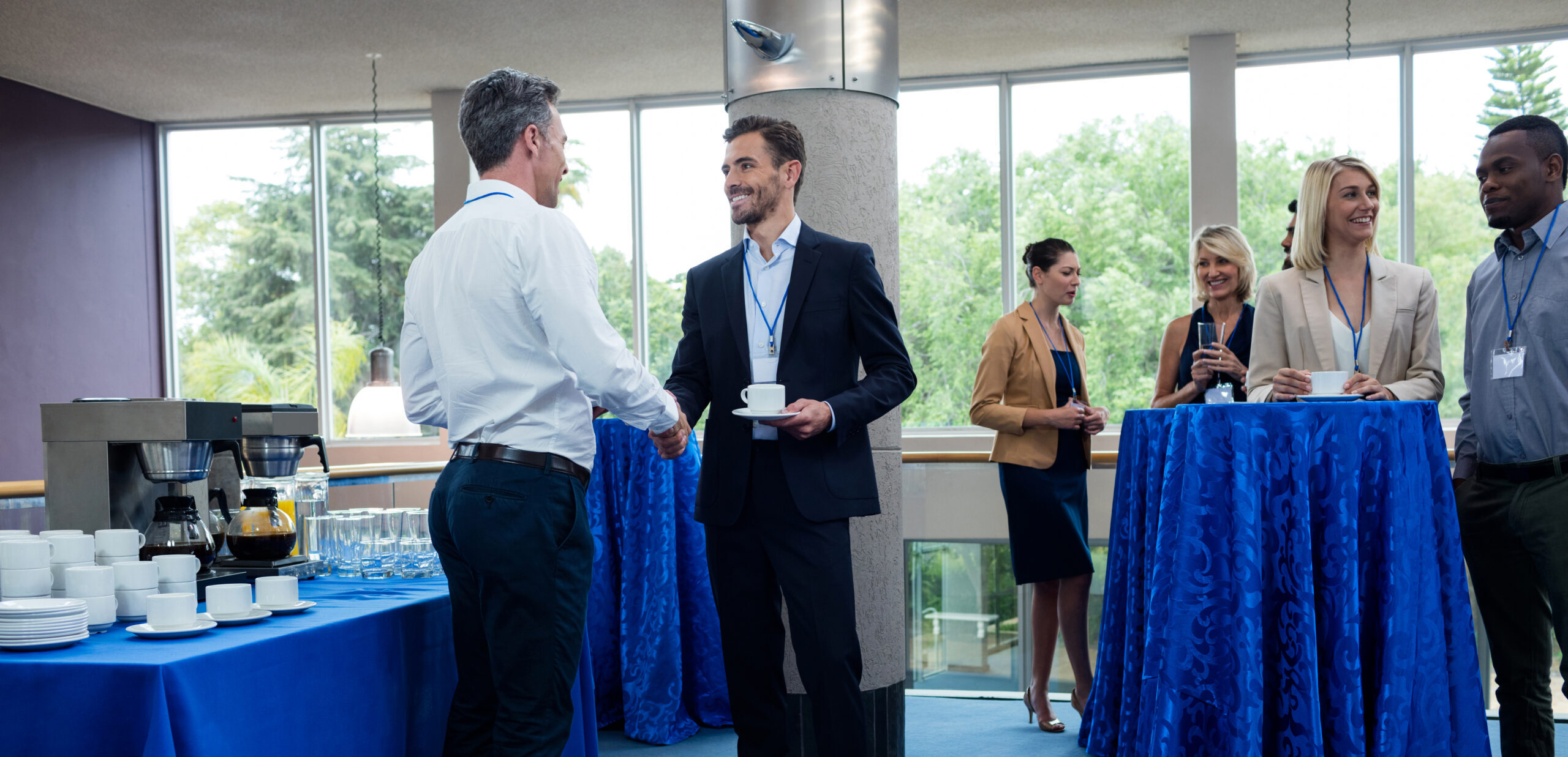 business executives interacting with each other while having coffee