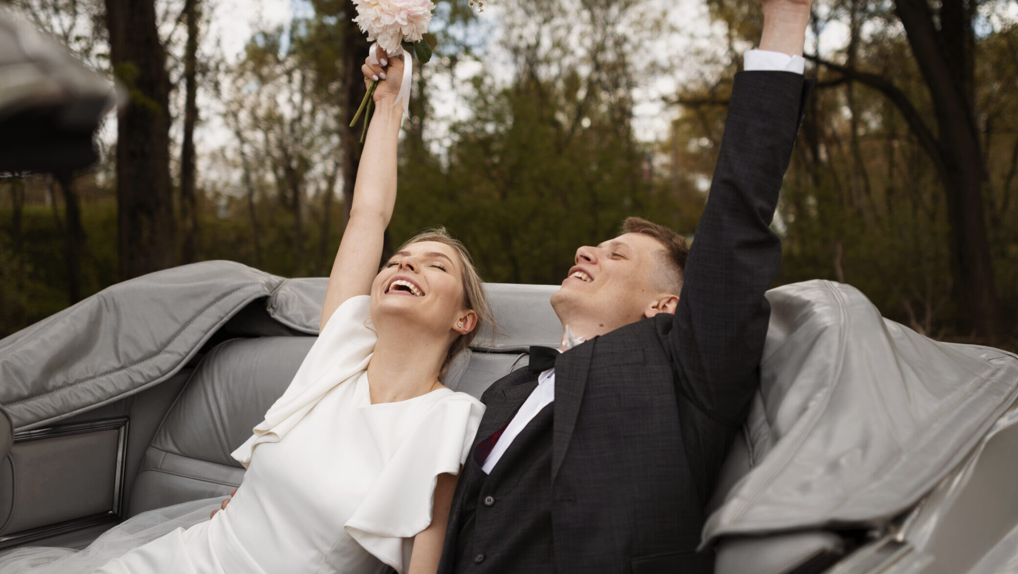 couple celebrating their just married car